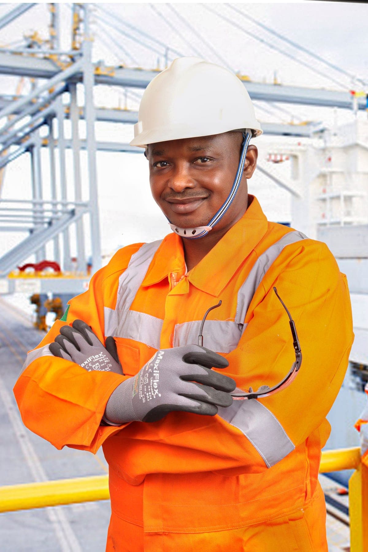 Industrial worker wearing a hard hat, protective gloves, safety glasses and high-visibility clothing